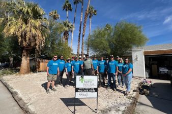 NNSS volunteers stand with a homeowner at his property.