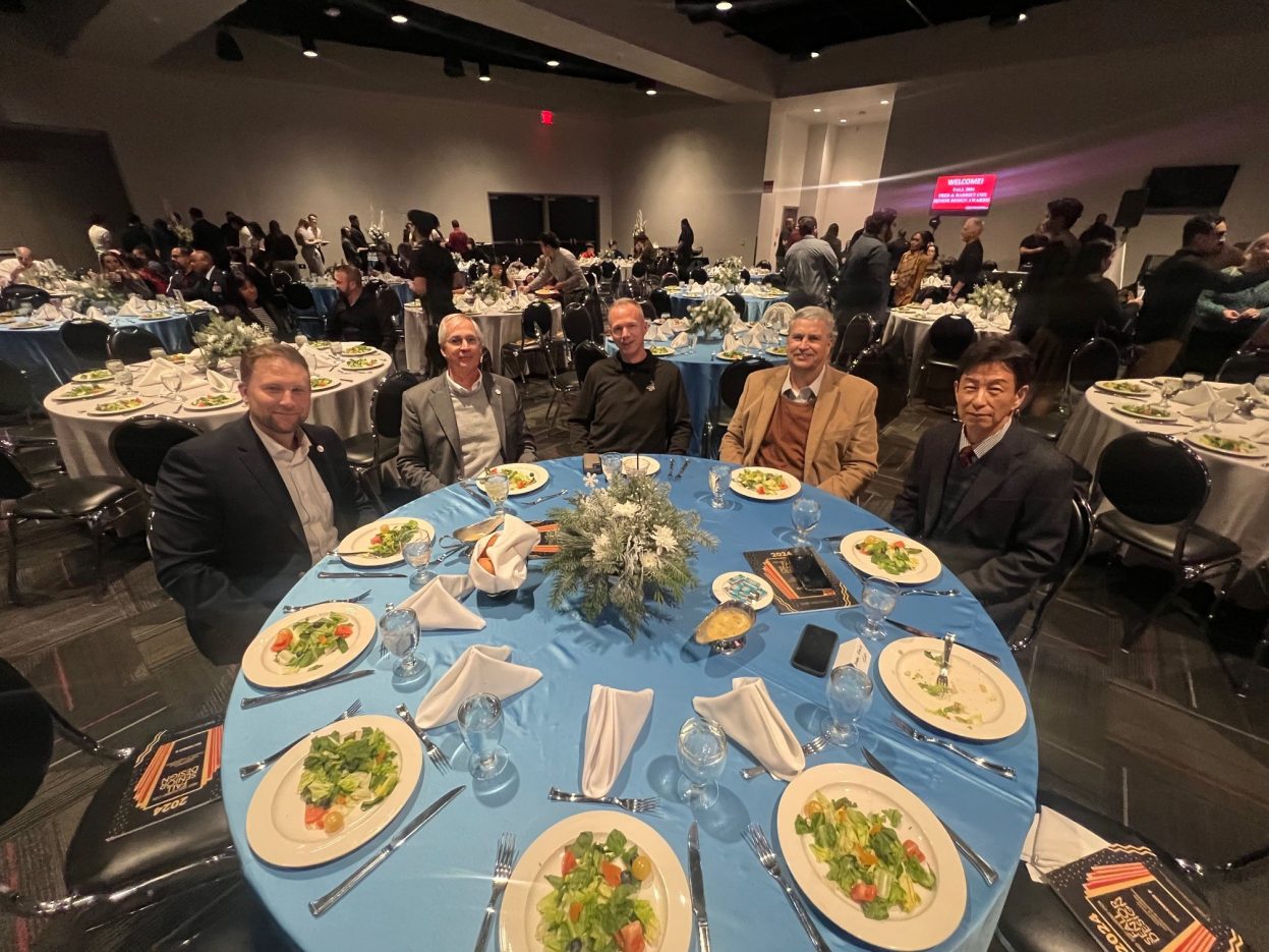 Five NNSS employees sit at an award dinner table.