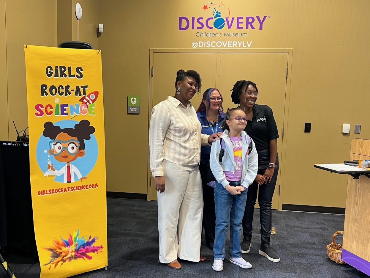 Three women STEM leaders meet a student.