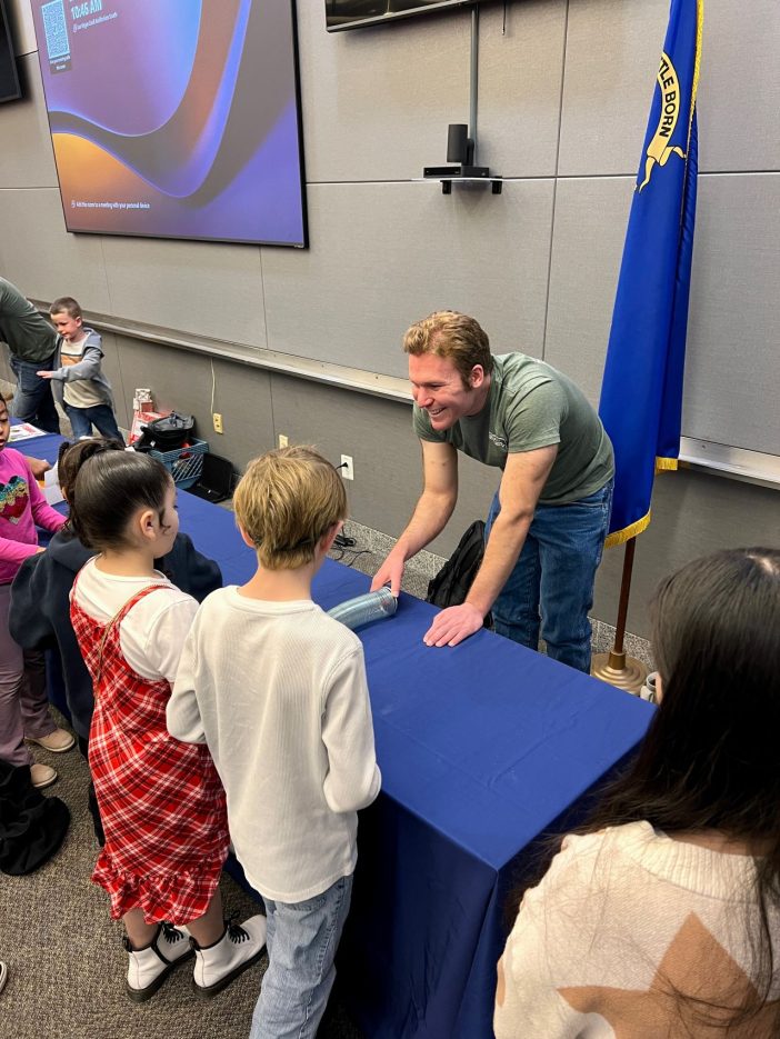 A NNSS employee demonstrates a geology experiment to students.