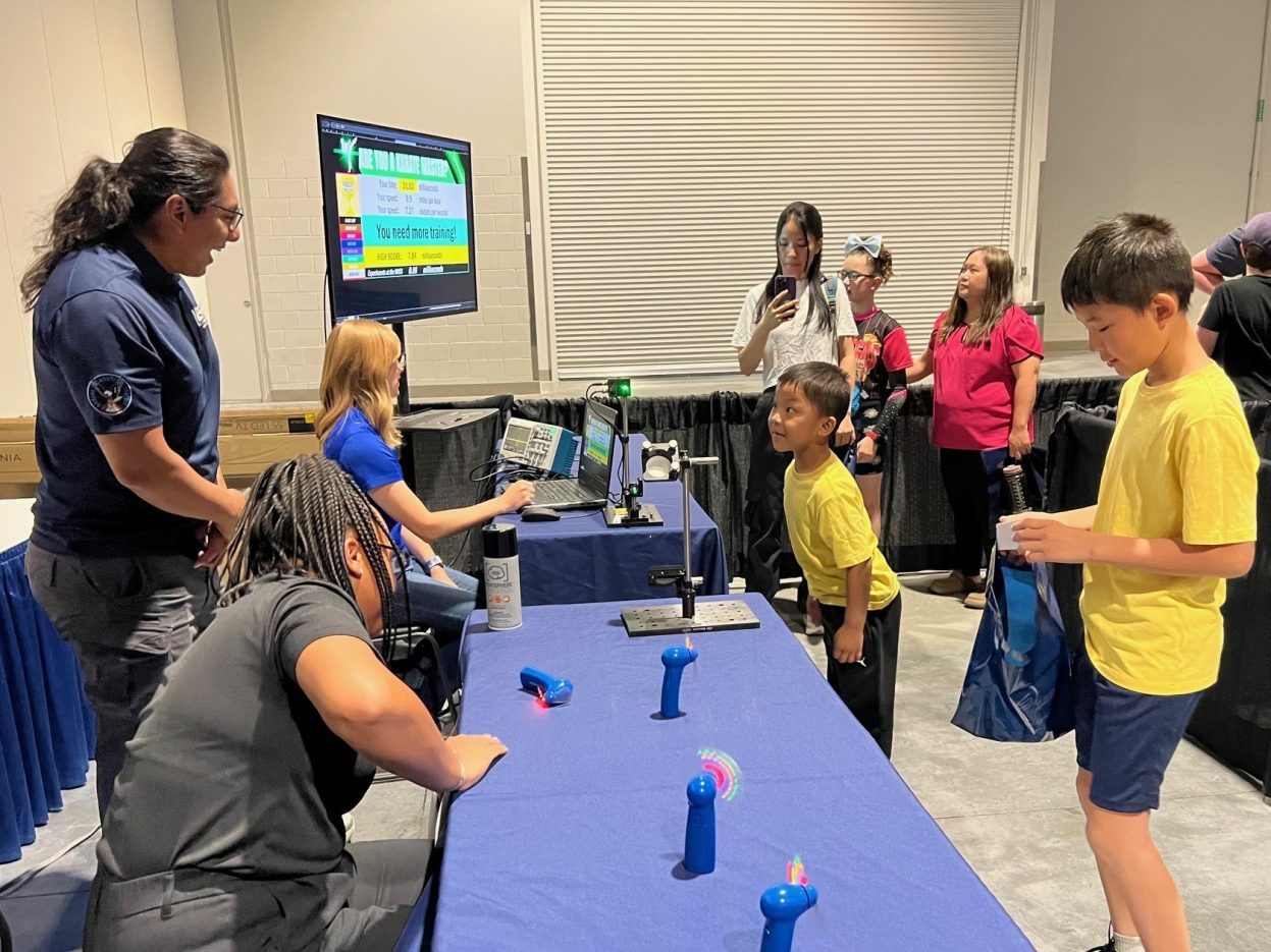 A student interacts with a laser demonstration.