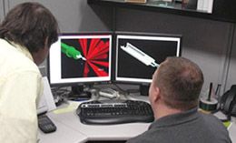 Engineer Joe Delash and Designer Eric Huffman look at images on two computer monitors