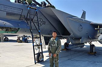 Damian Hicks standing in front of military aircraft