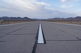 crack sealing and new white lines on airport runway