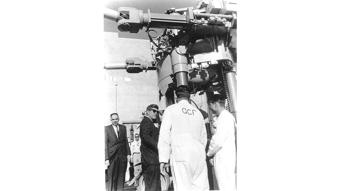 President Kennedy and AEC Chairman Glenn T. Seaborg look at the Beetle during President Kennedy’s visit to the Nuclear Rocket Development Station (Area 25) on Dec. 8, 1962. A remote handling vehicle designed to allow users to handle radioactive material, the Beetle fascinated the president.