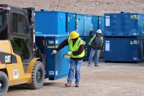 Crews unload waste containers at the Radioactive Waste Management Complex, Area 5, NNSS