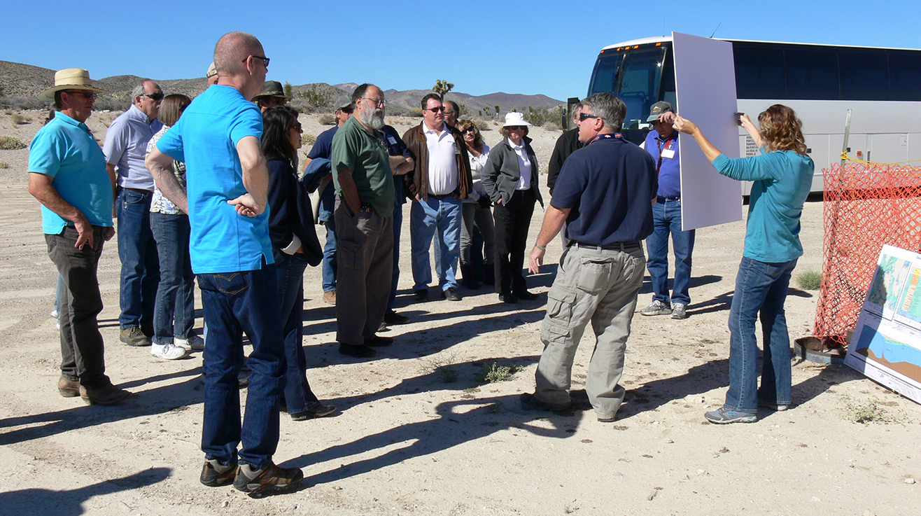 An EM Nevada Program manager briefs members of the Nevada Site Specific Advisory Board on groundwater activities at Yucca Flat. (Photo taken prior to COVID-19.)