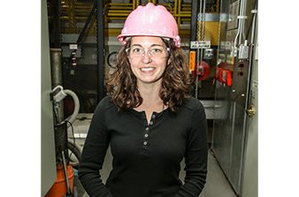 Marylesa Howard in pink hard hat, safety glasses and black shirt