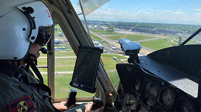 pilot inside helicopter over looking Indianapolis 500 track