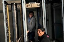 Principal Engineer Michael Misch (background) continues build on unit cabinets at LLNL with Engineer Koby Sugihara (foreground).