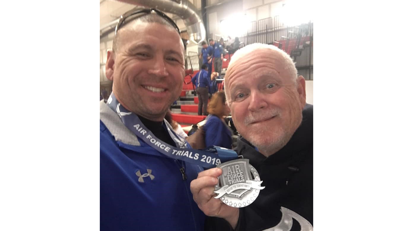 Kevin James (left), a U.S. Air Force Wounded Warrior, with his father following placing silver in cycling at the 2019 Air Force Trials.