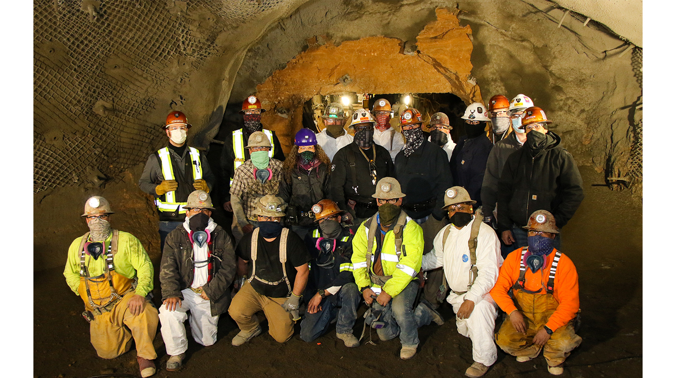 First shift crew poses for photo in front of the newly-completed tunnel.