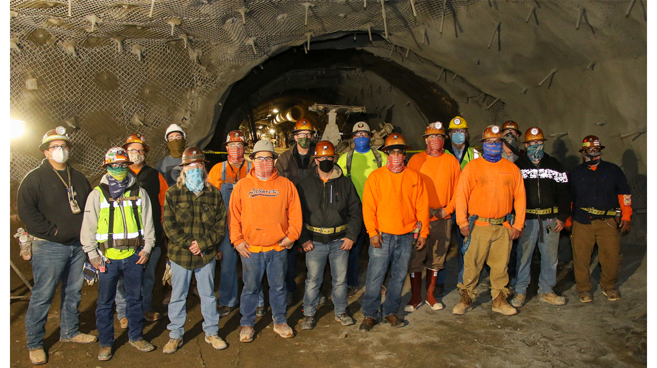 Second shift crew poses for photo in front of the newly-completed tunnel.