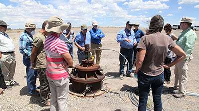 group of people observing a well at the NNSS