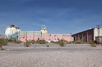 pink building with white tank to left and another building to right