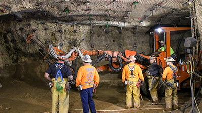 six miners underground at U1a with large construction vehicle