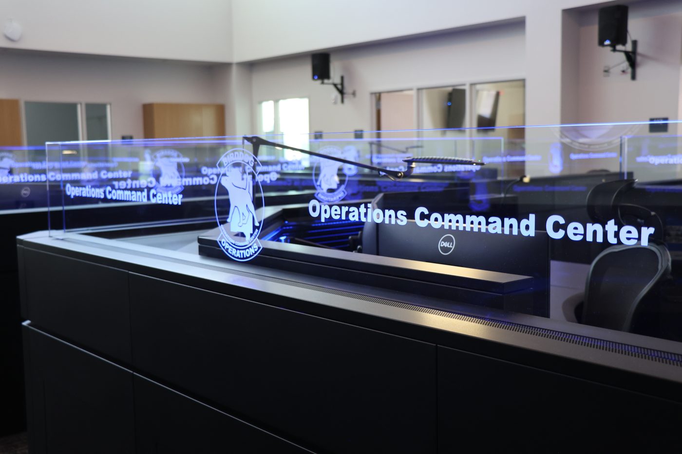 Clear sign above a work station with blue backlight that says Operations Command Center and has a dog logo next to it
