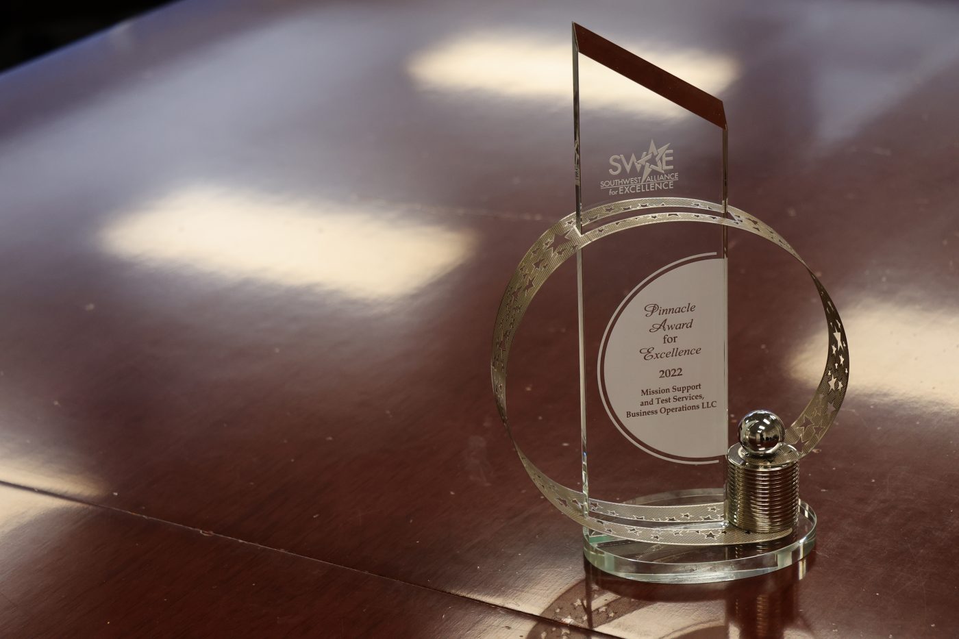 glass award sitting on dark brown table