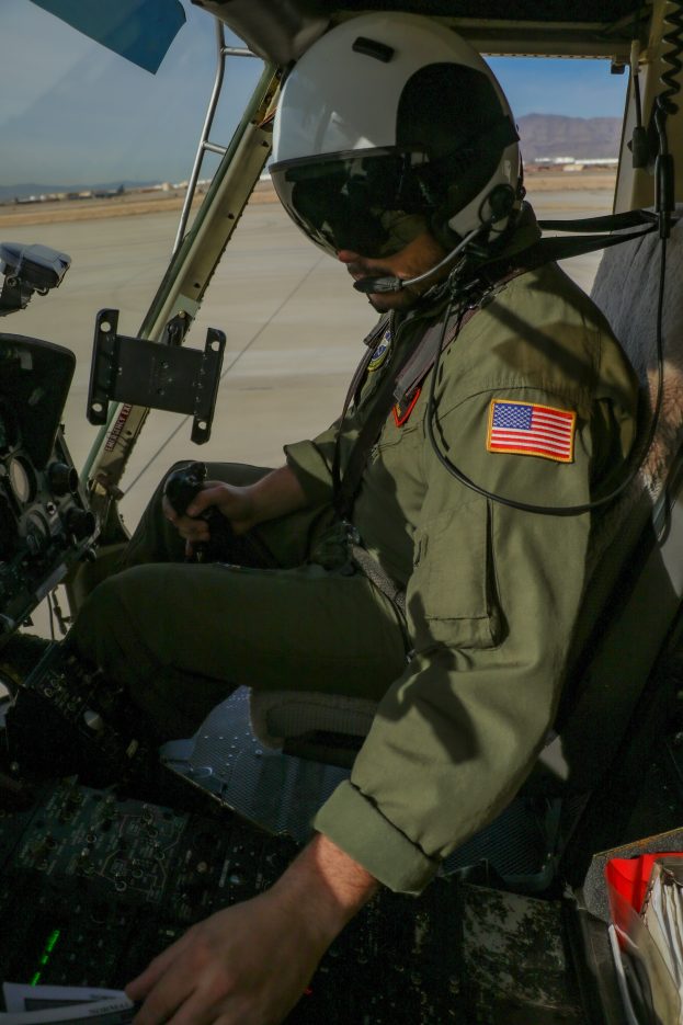 A pilot prepares a helicopter for flight.