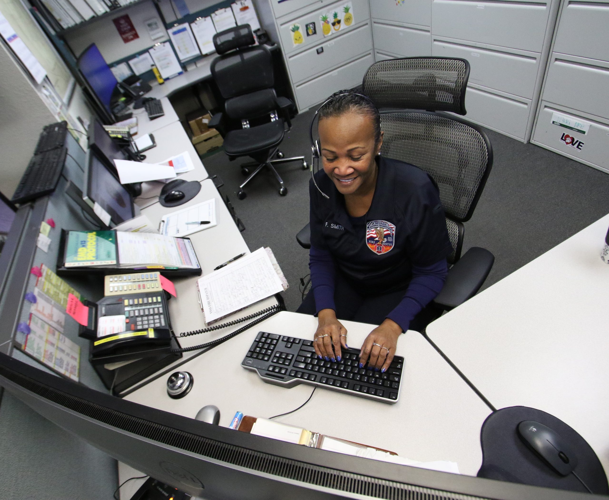 female dispatcher typing at her computer