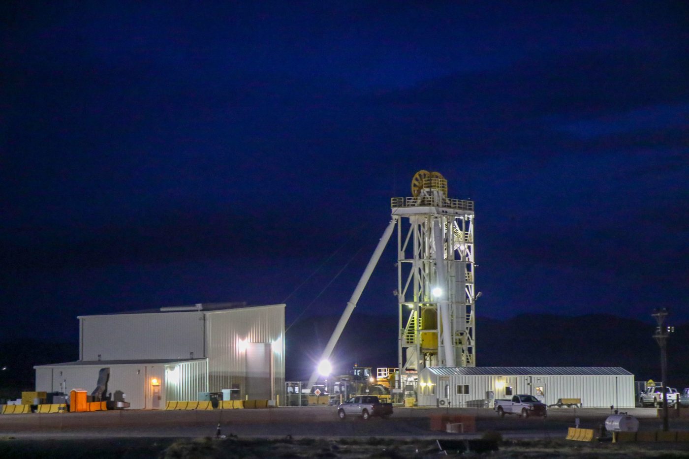 An above-ground vertical shaft for the U1a Complex with a nighttime sky.