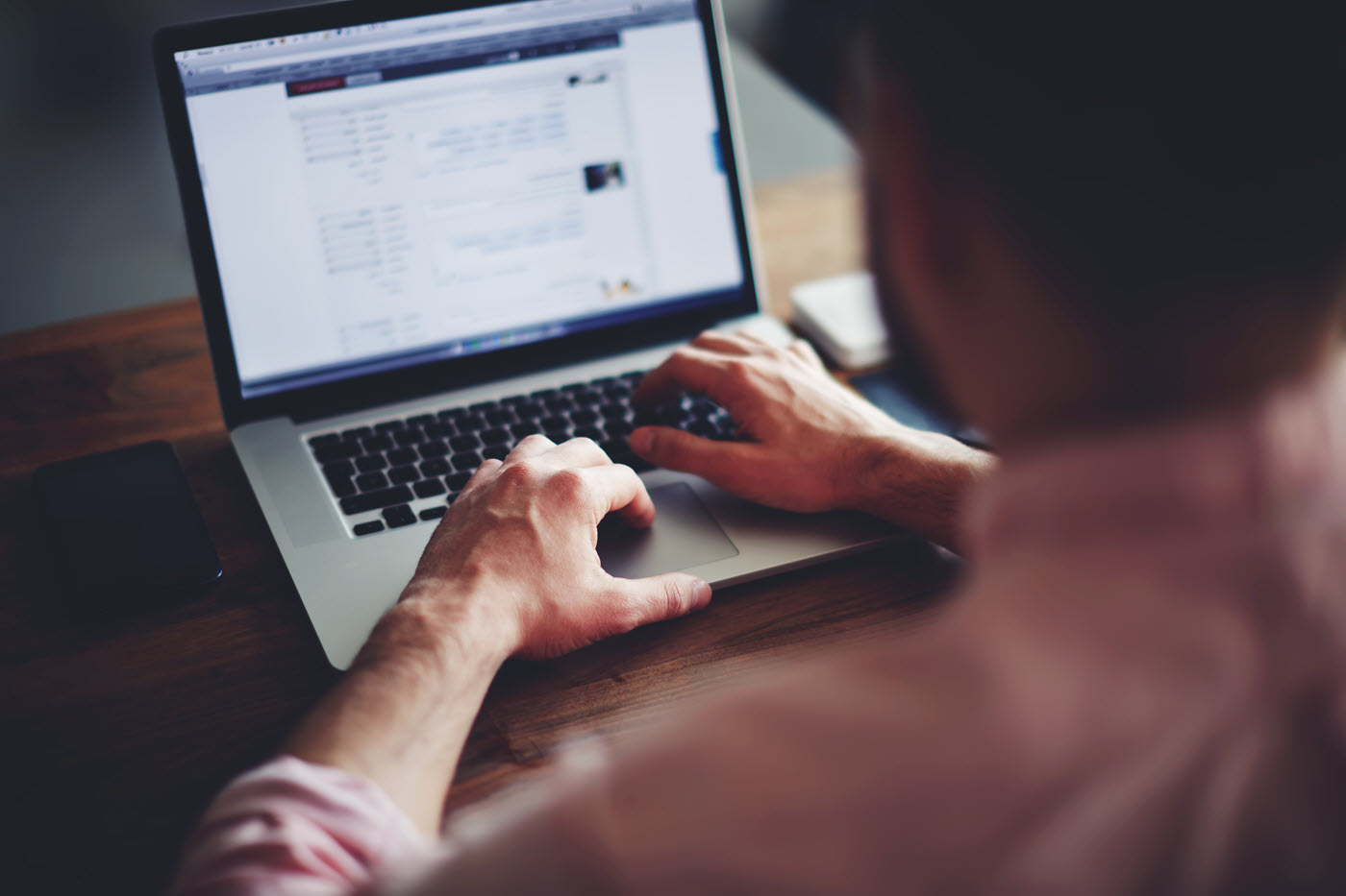 image of man logging into laptop computer