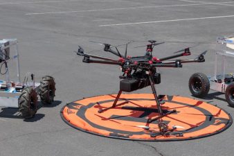 two small robots and a UAS sit ready for a demonstration in the UNLV parking lot
