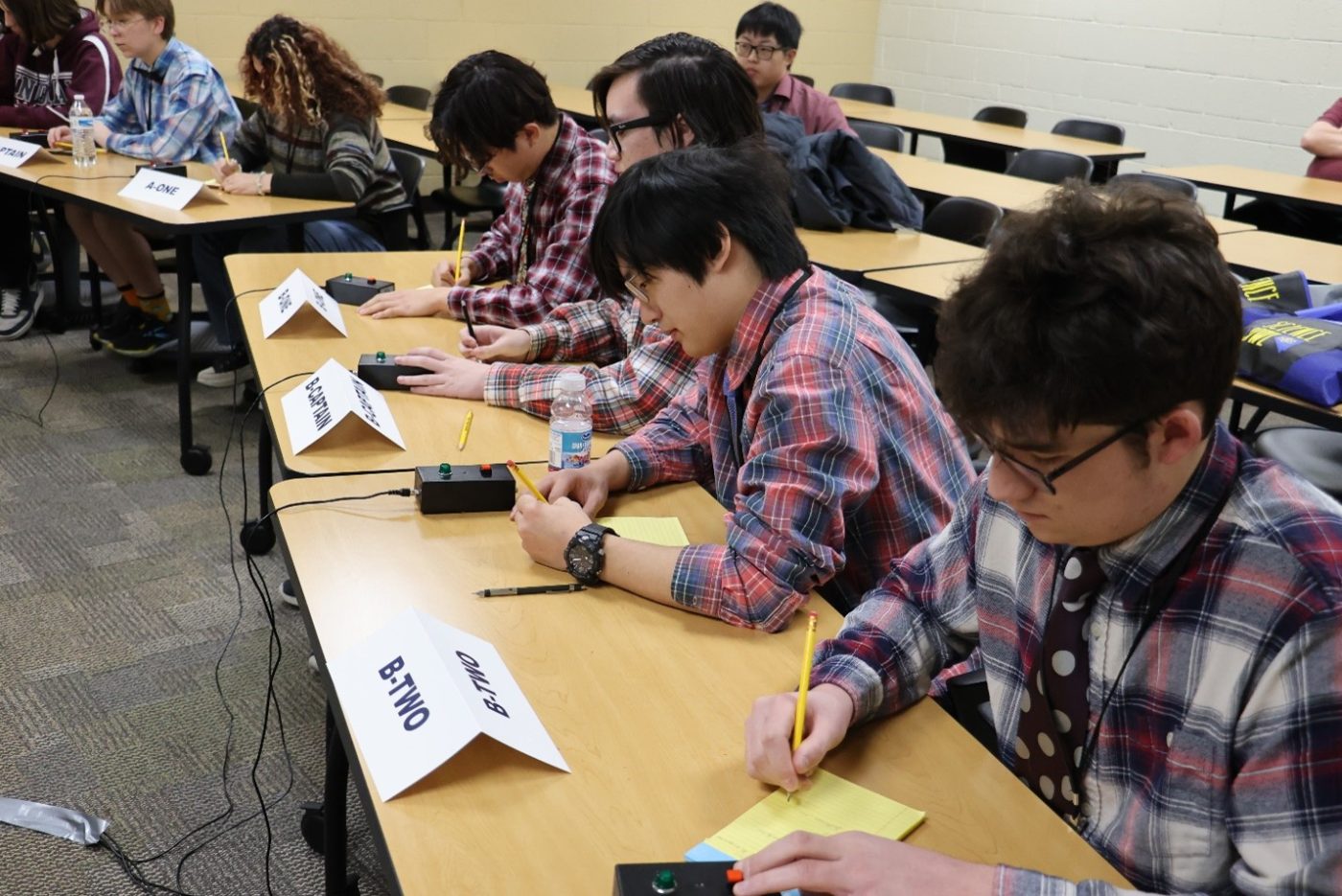 Students take notes inside a classroom. 