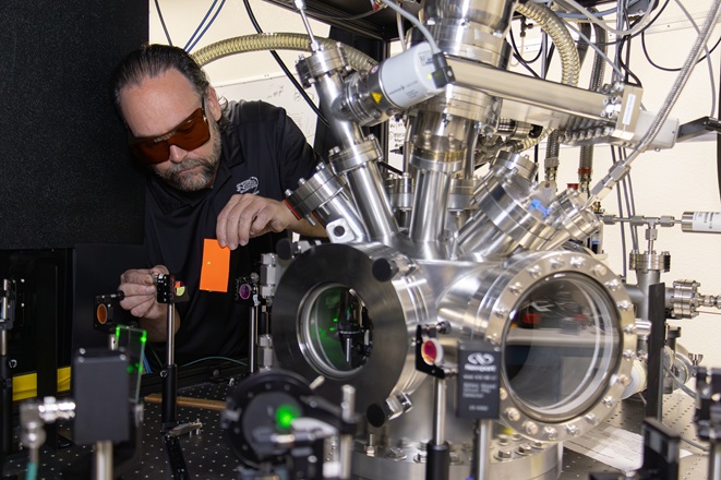 NNSS scientist Eric Dutra aligns a laser for material ablation experiments.