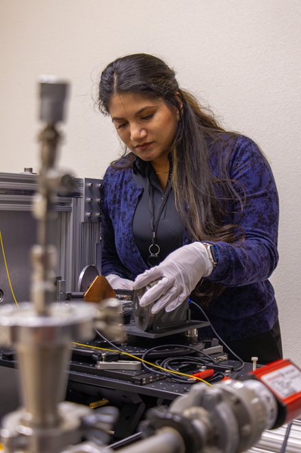 NNSS scientist Showera Haque makes adjustments to an x-ray spectrometer.