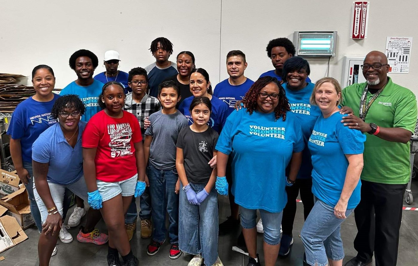 A group of smiling volunteers pose for a photo.