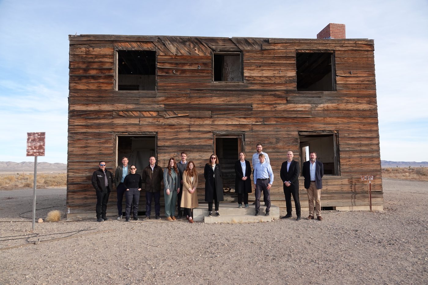 group of people pose in front of Apple 2 house