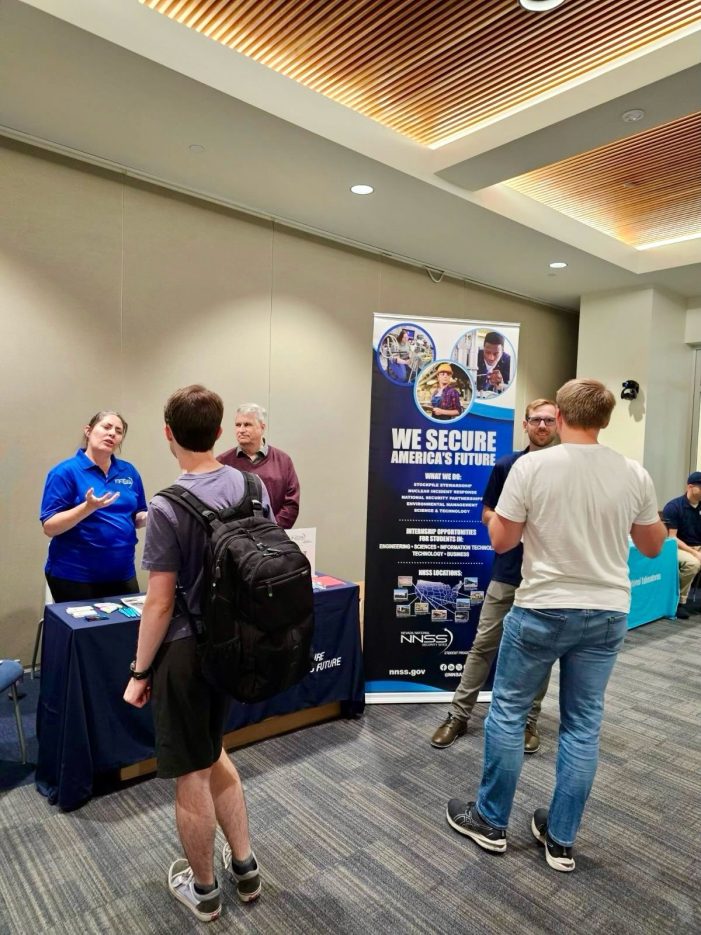 employees talking to students at a career fair