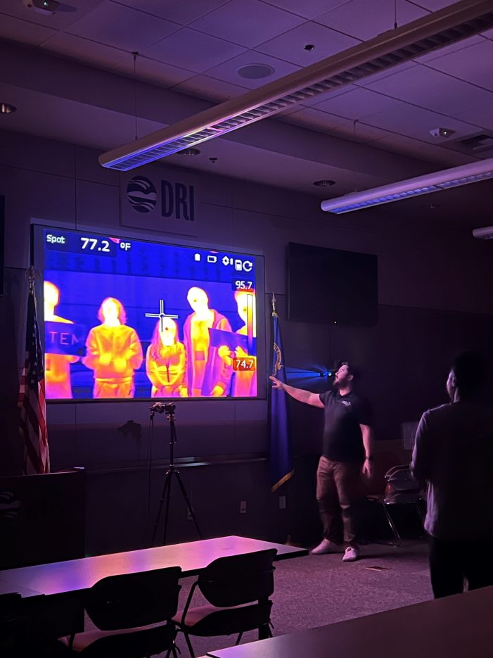 A presenter shows images from a thermal camera.