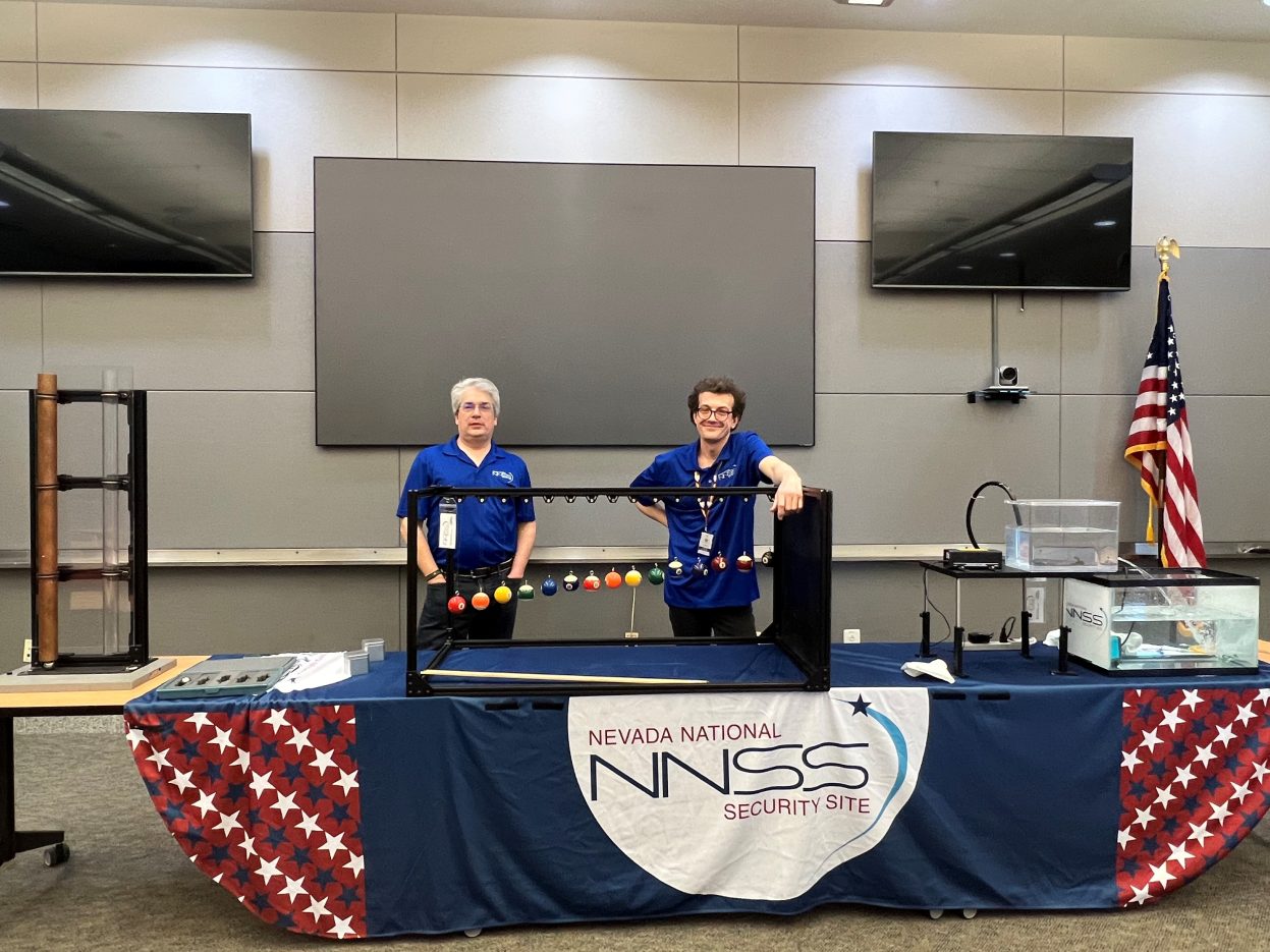 Two NNSS presenters share demonstrations at a table.