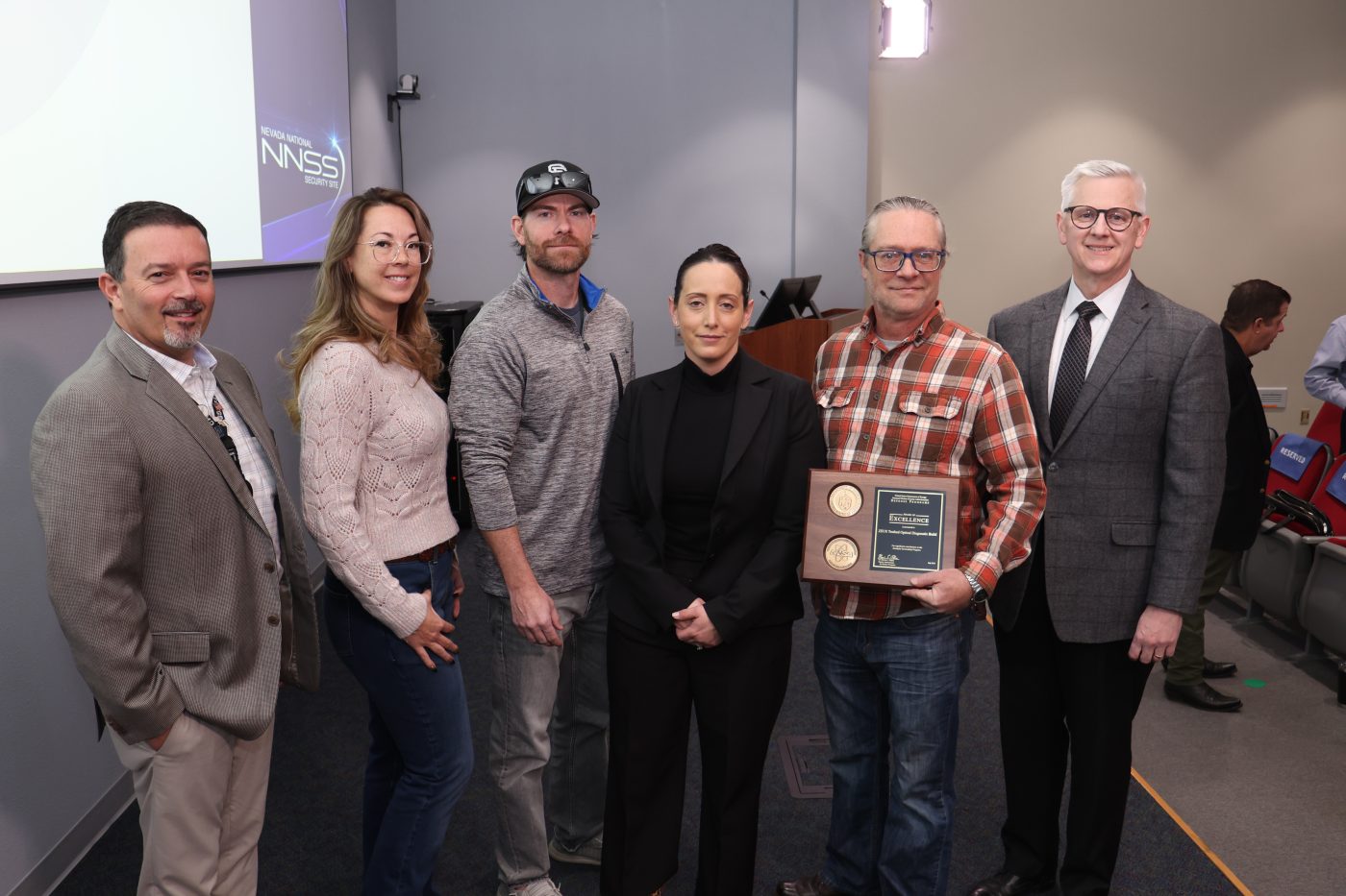 project team holding a plaque