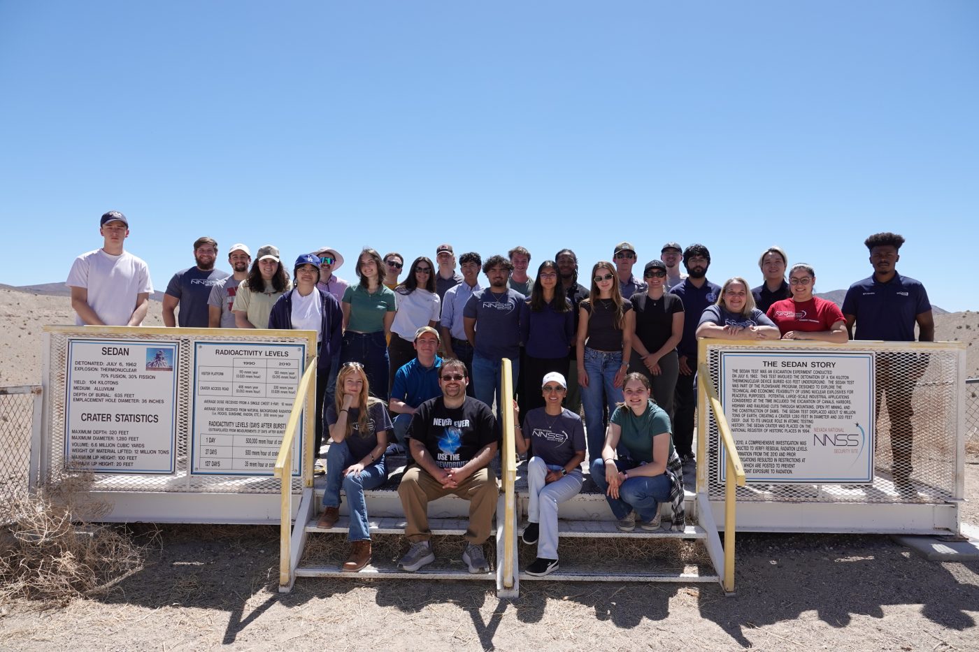 students posed for a picture in front of Sedan Crater