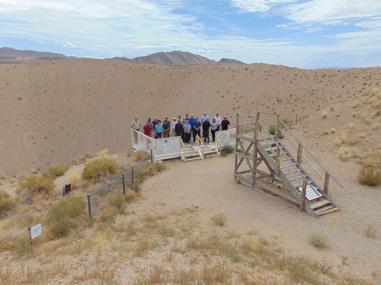 group photo standing at sedan crater