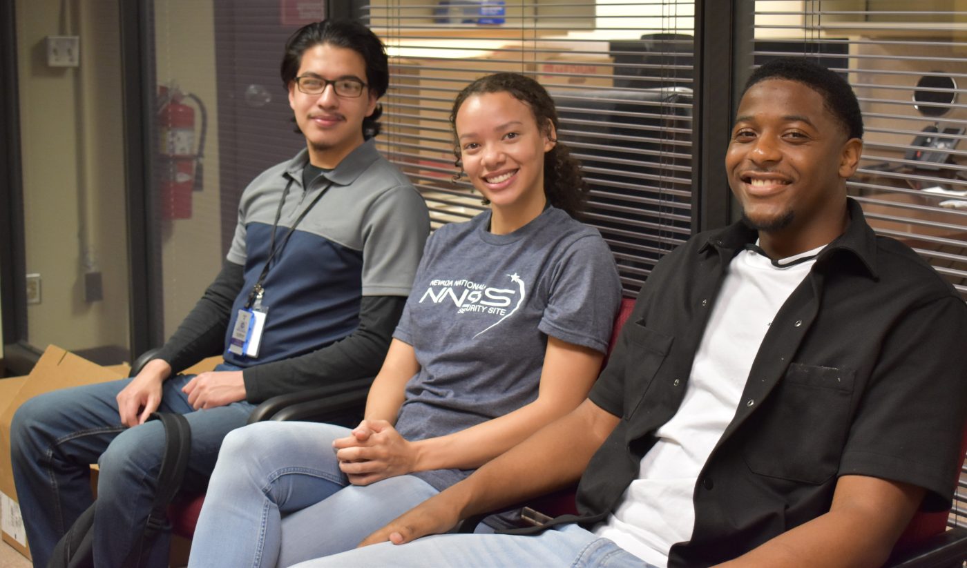 Three students smile at the NNSS.