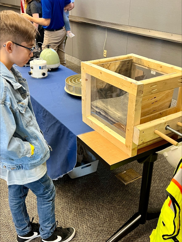 A student examines a science demonstration.