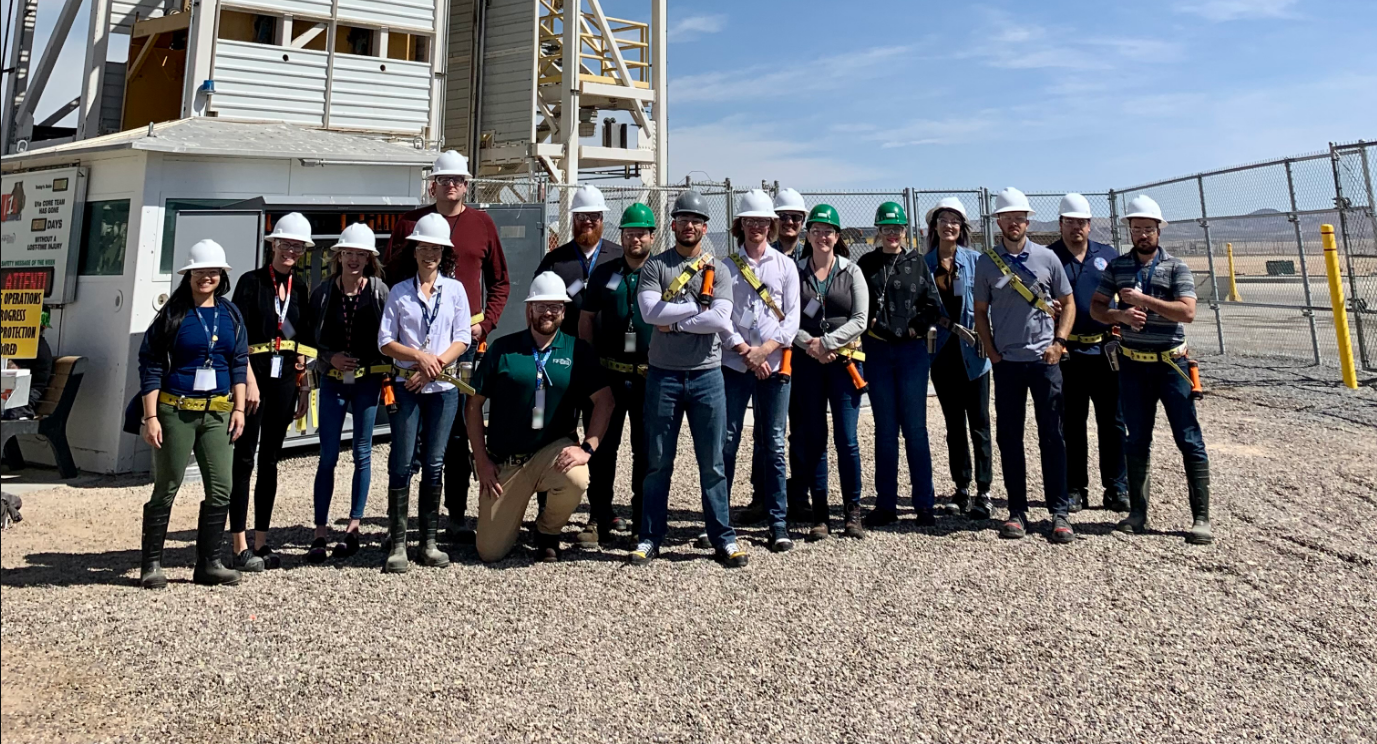 group of employees standing with hard hats on