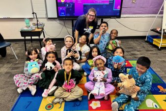 students sitting in front of NNSS employee in classroom
