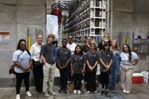 Students stand in front of the NNSS Integrated Test Stand.
