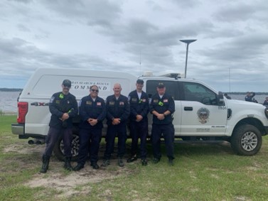 Five members of Nevada Task Force 1 in front of a white truck.