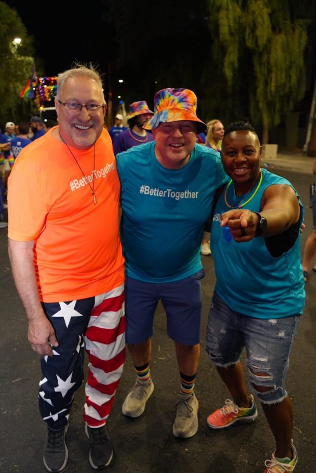 Three NNSS employees smile at Las Vegas PRIDE.