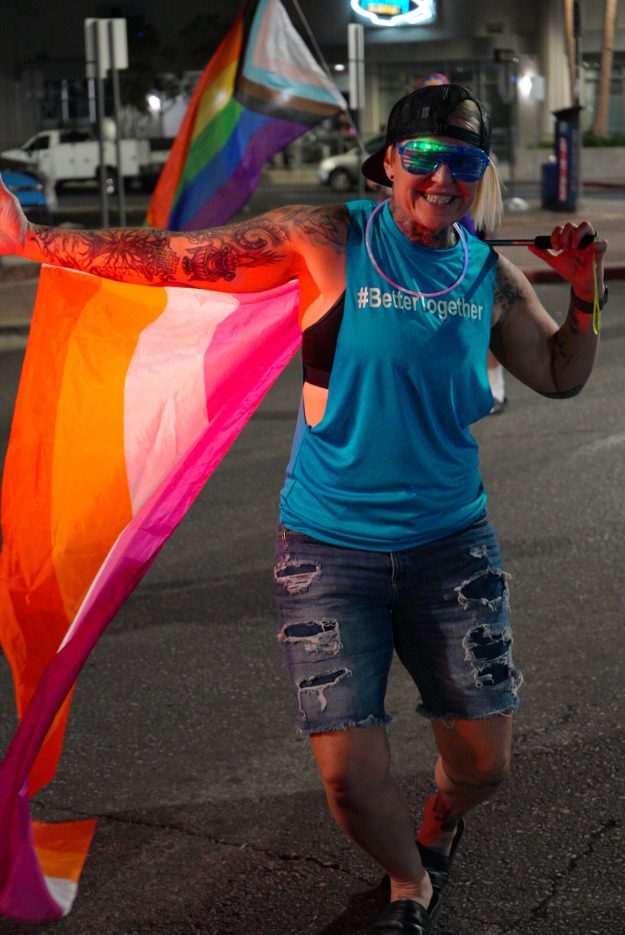 An employee waves a Pride Flag at Las Vegas PRIDE.