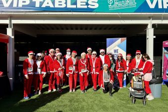 Employees wearing red and white Santa suits.