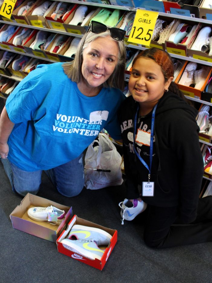 A student and NNSS volunteer in a shoe trailer.