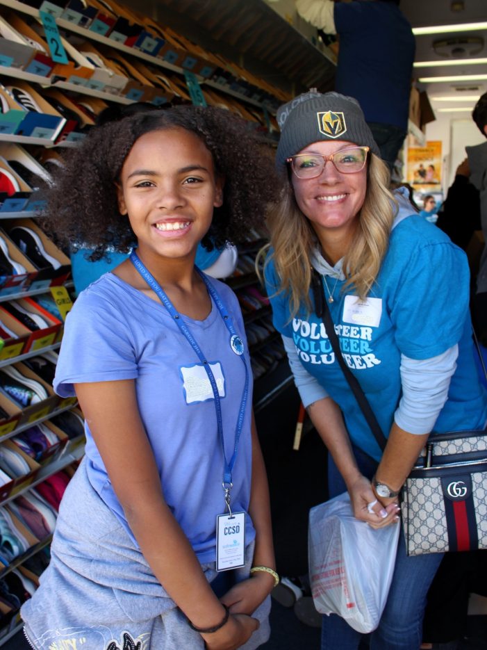 A student and NNSS volunteer in a shoe trailer.