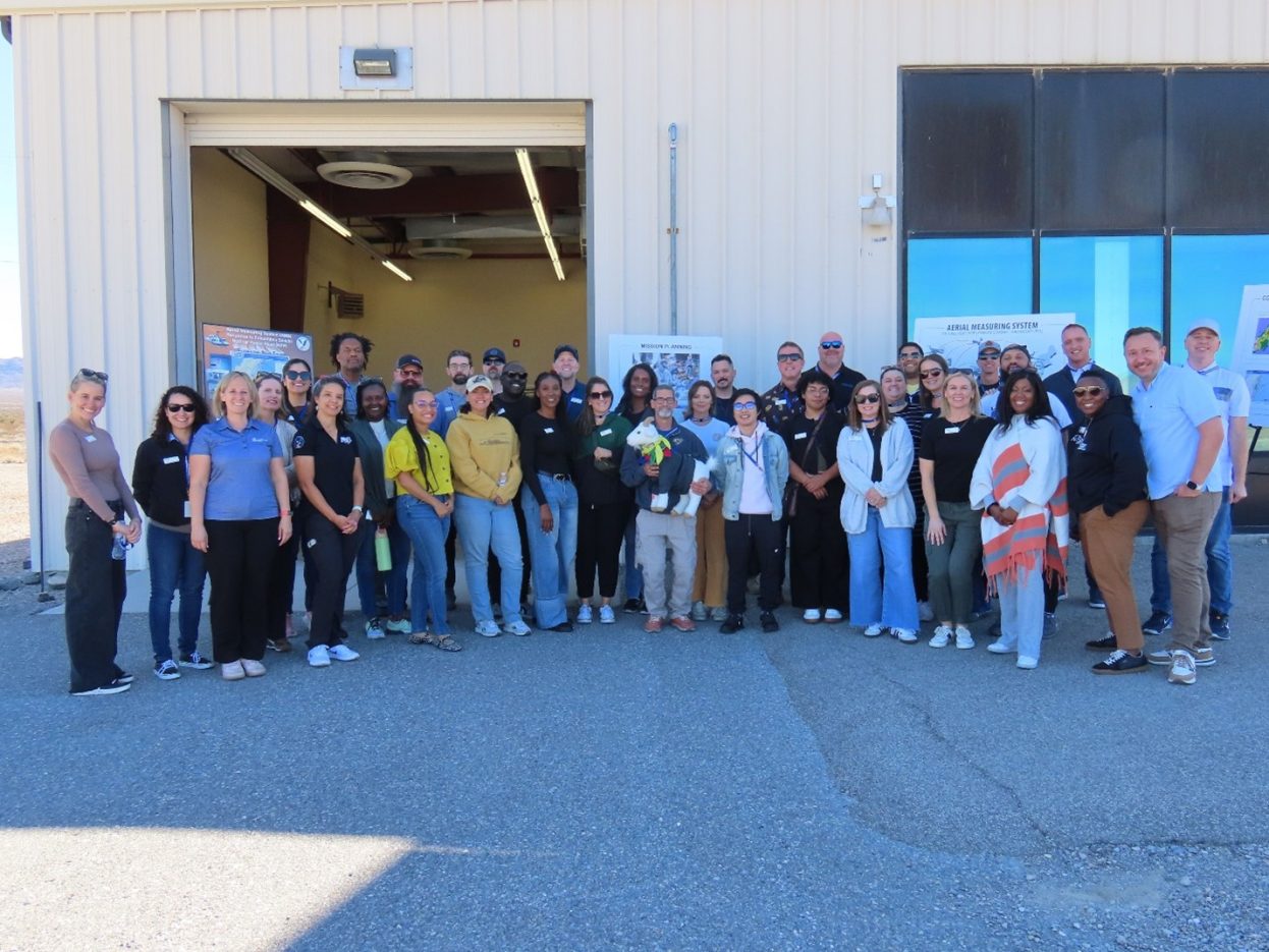 group of 20+ people standing in front of a building